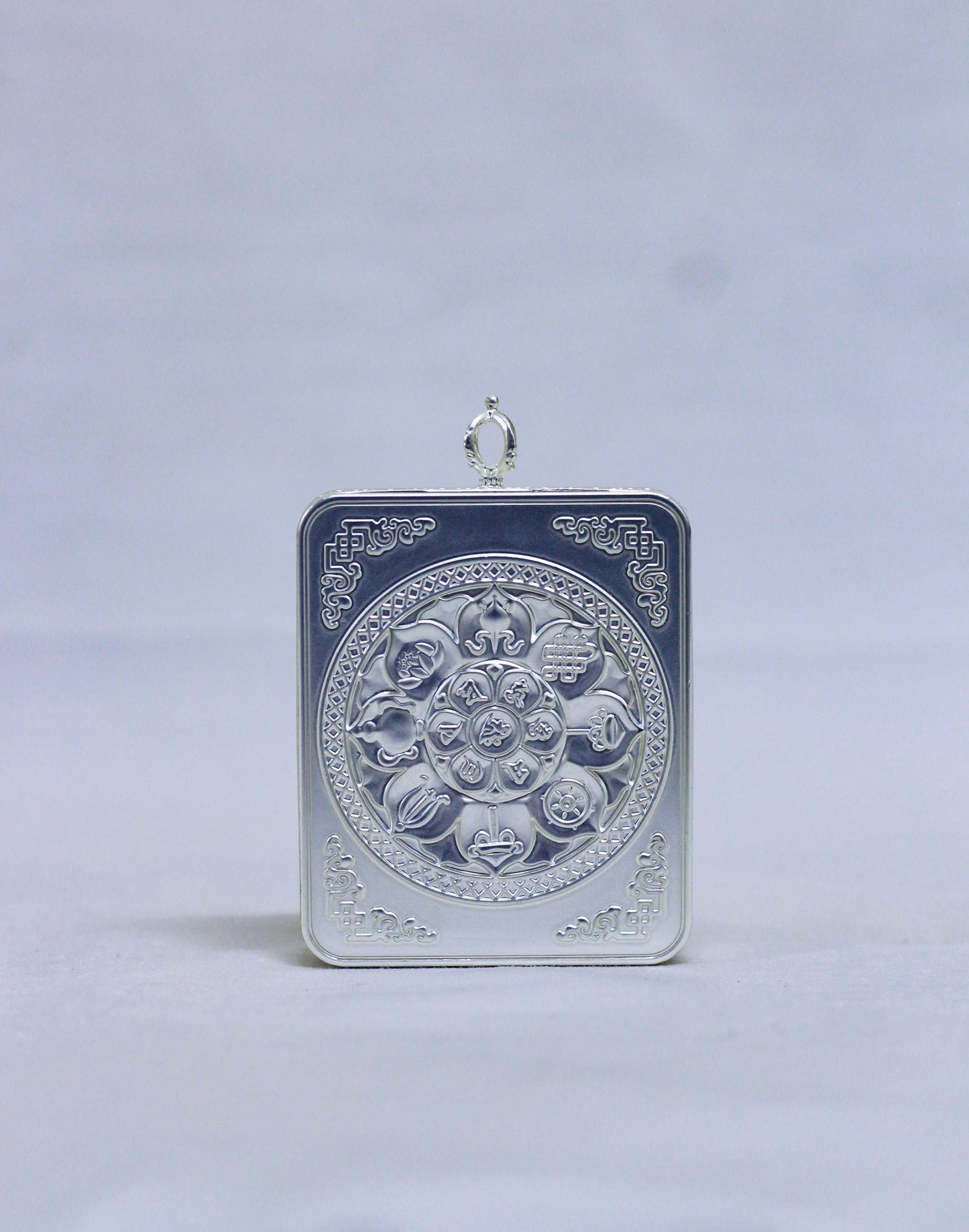 Back view of Amitabha Buddha butti thangka pendant showing silver-toned handcrafted metal finish and pendant structure
