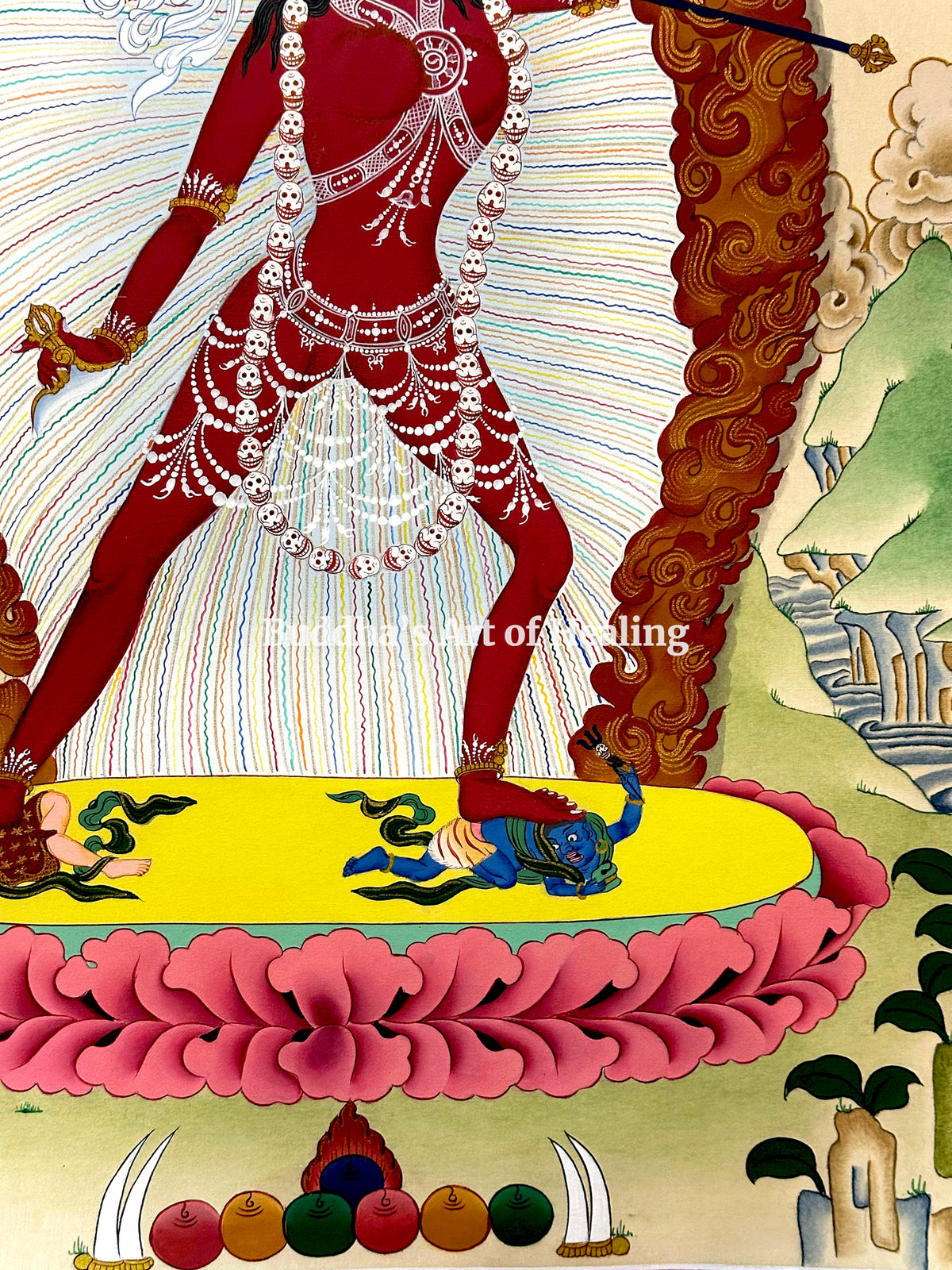 Vajrayogini standing on a pink lotus and yellow sun disc above two postrate figures