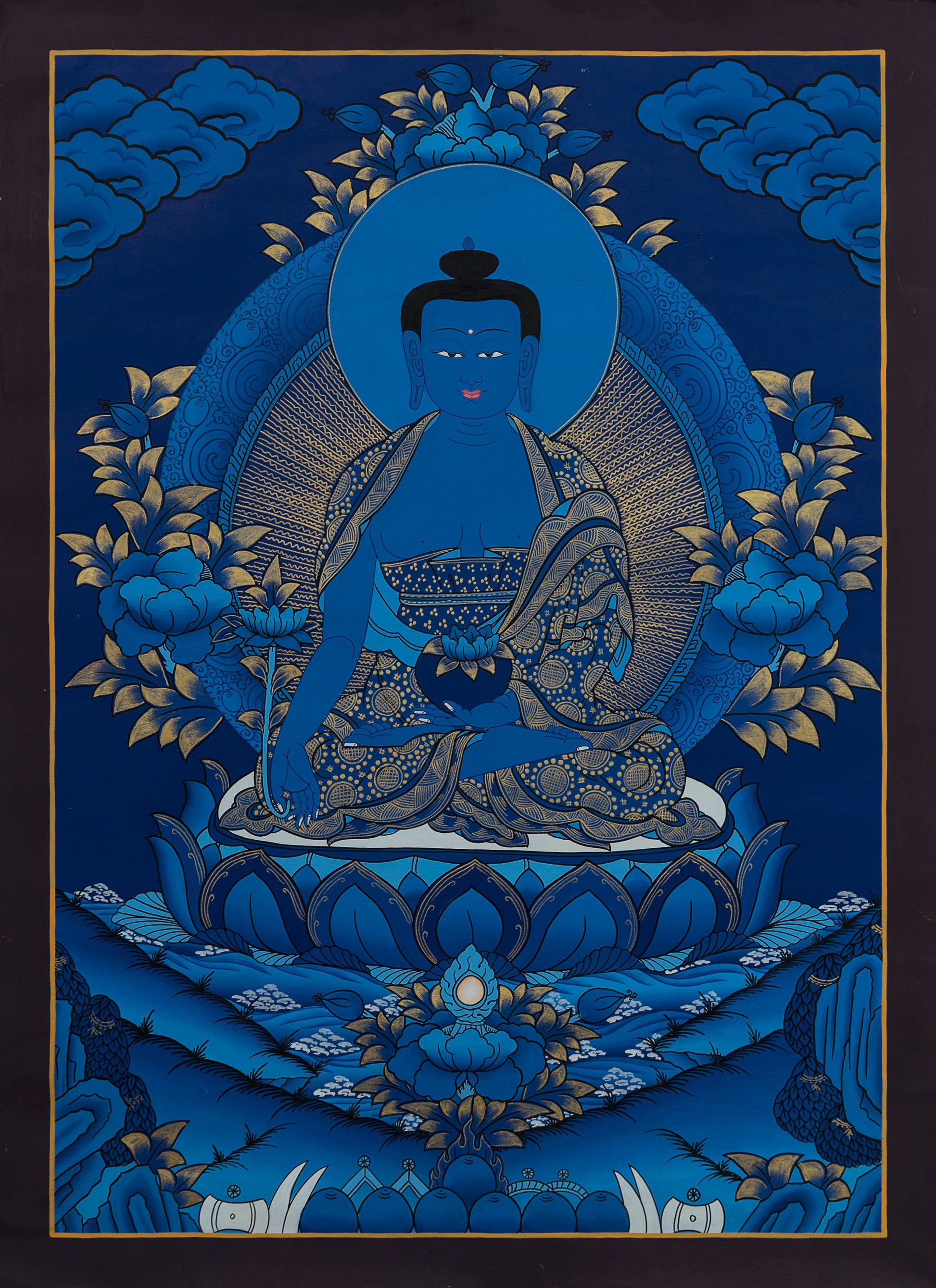 Medicine Buddha with gold accents on a blue background