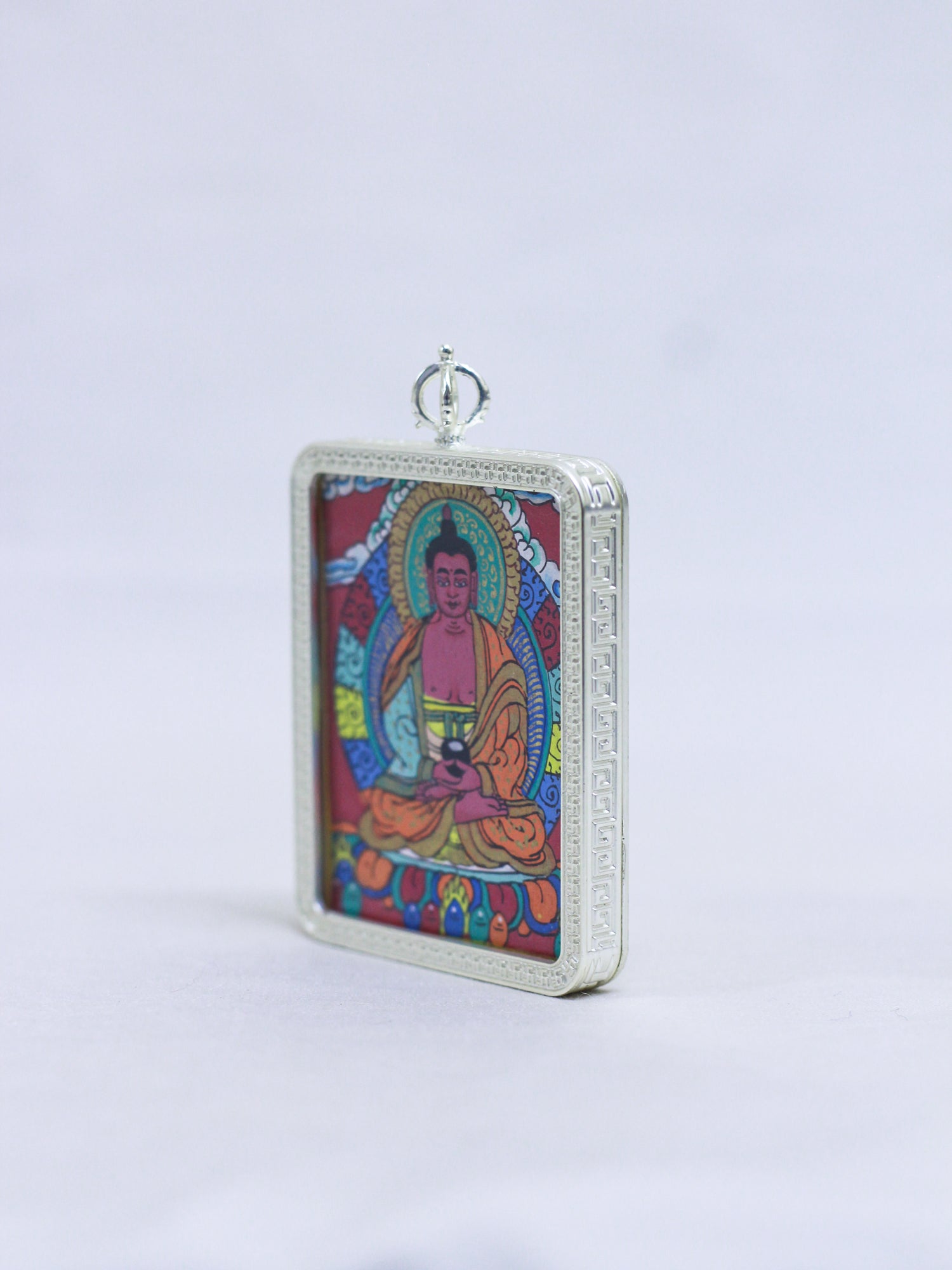 Side view of Amitabha Buddha Butti thangka pendant showing intricate Buddhist art, fine detailing, and handmade craftmanship