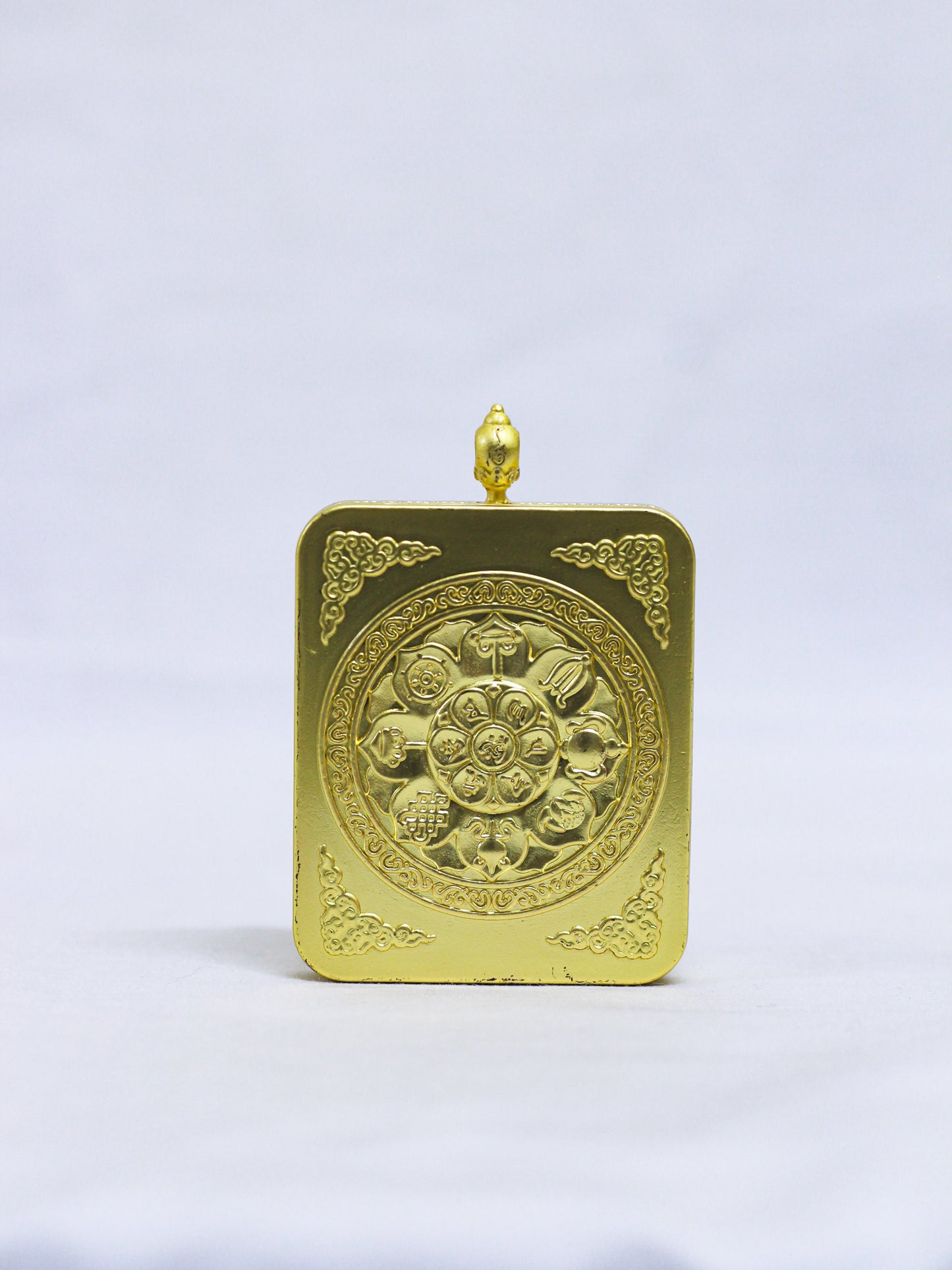 Back of the Shakyamuni Buddha butti thangka pendant engraved with the Eight Auspicious Symbols and sacred lotus motif.