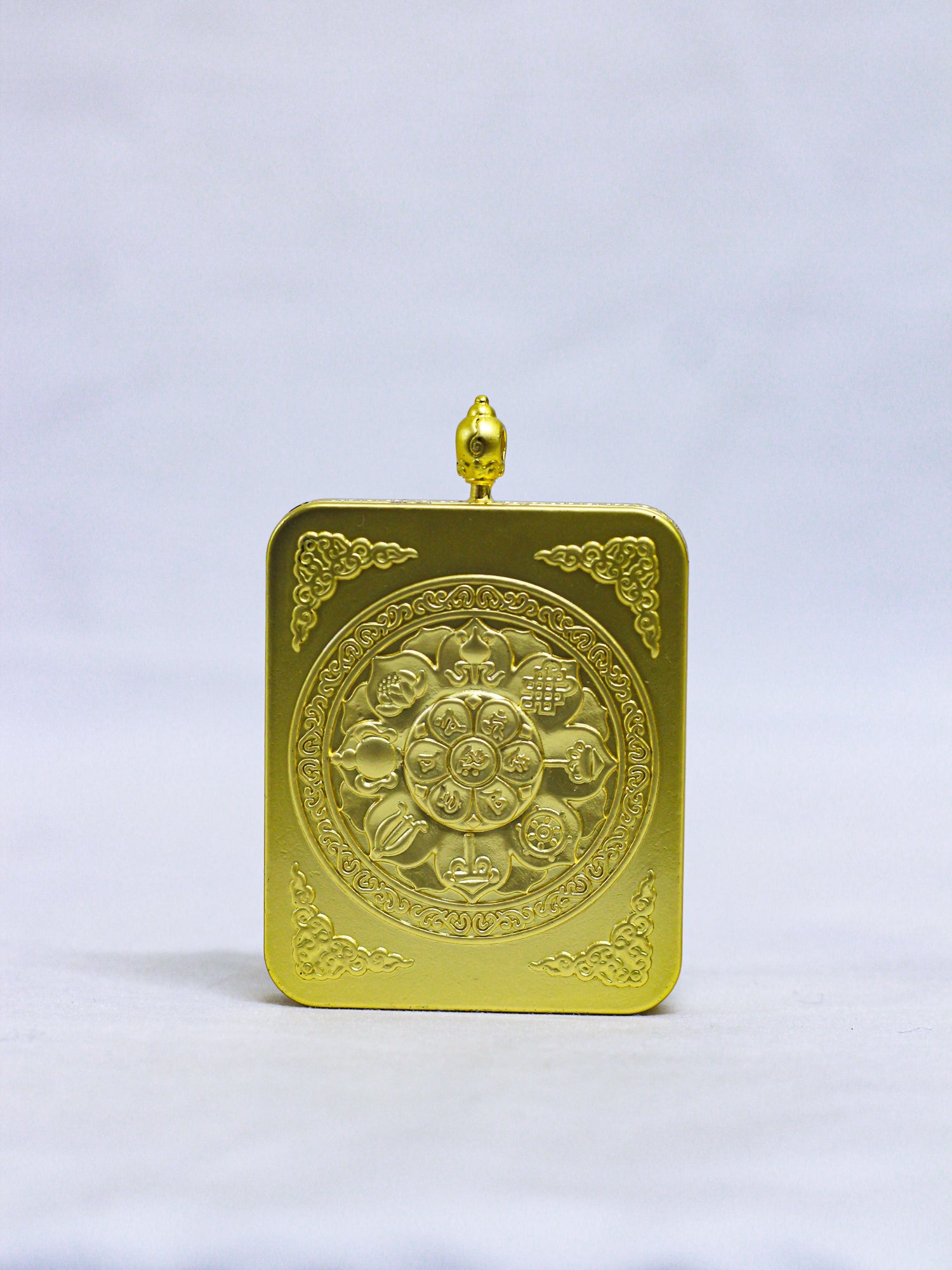 Back of an authentic Chenrezig Thangka Ghau locket engraved with a sacred Lotus Mandala, Eight Auspicious Symbols, floral corner motifs, and a decorative red coral-style stone.