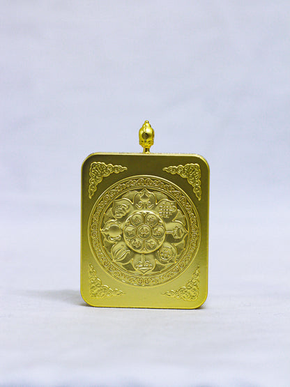 Back of an authentic Chenrezig Thangka Ghau locket engraved with a sacred Lotus Mandala, Eight Auspicious Symbols, floral corner motifs, and a decorative red coral-style stone.