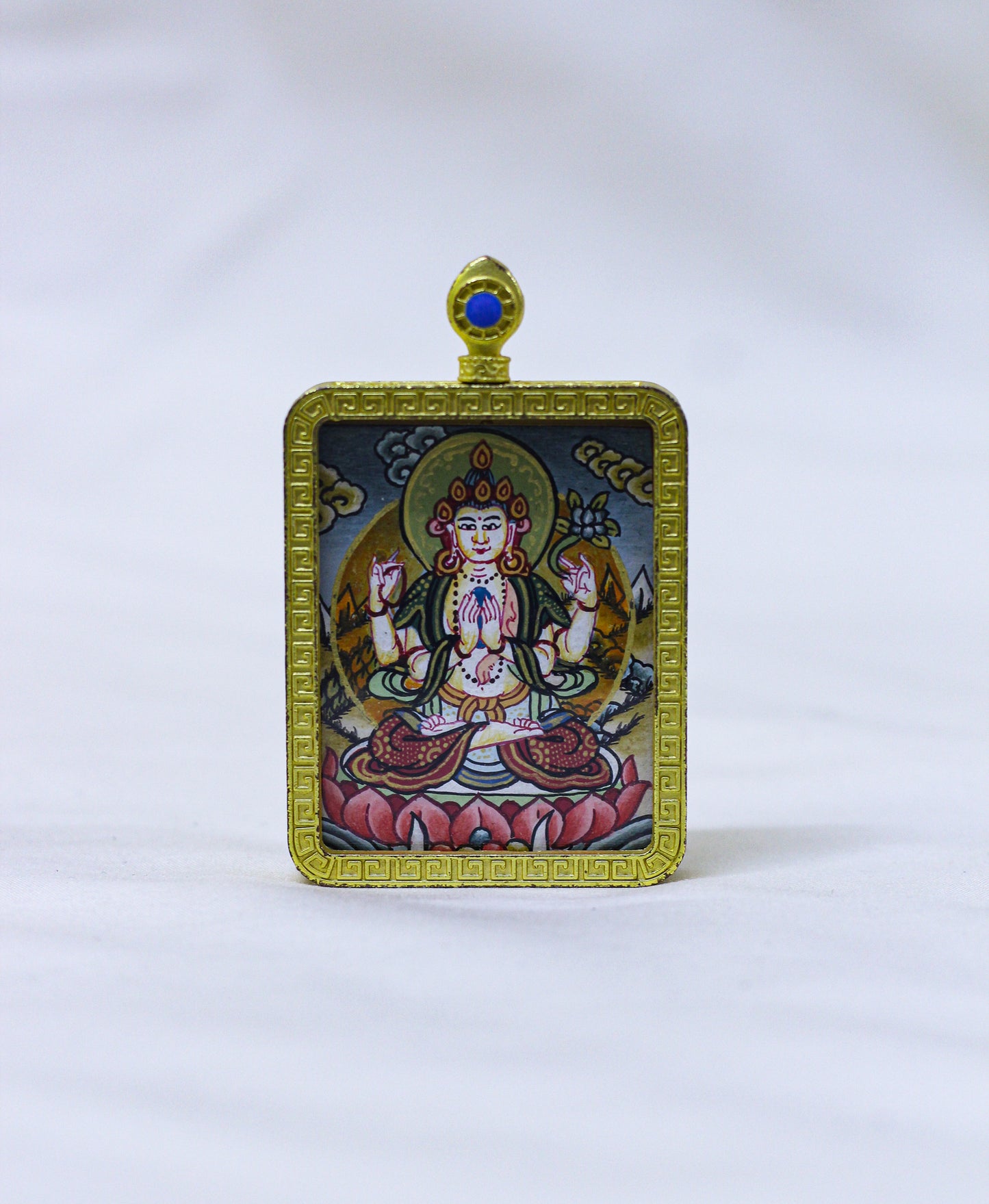 Square hand-painted Chenrezig butti thangka pendant featuring the Bodhisattva of compassion in a gold locket frame