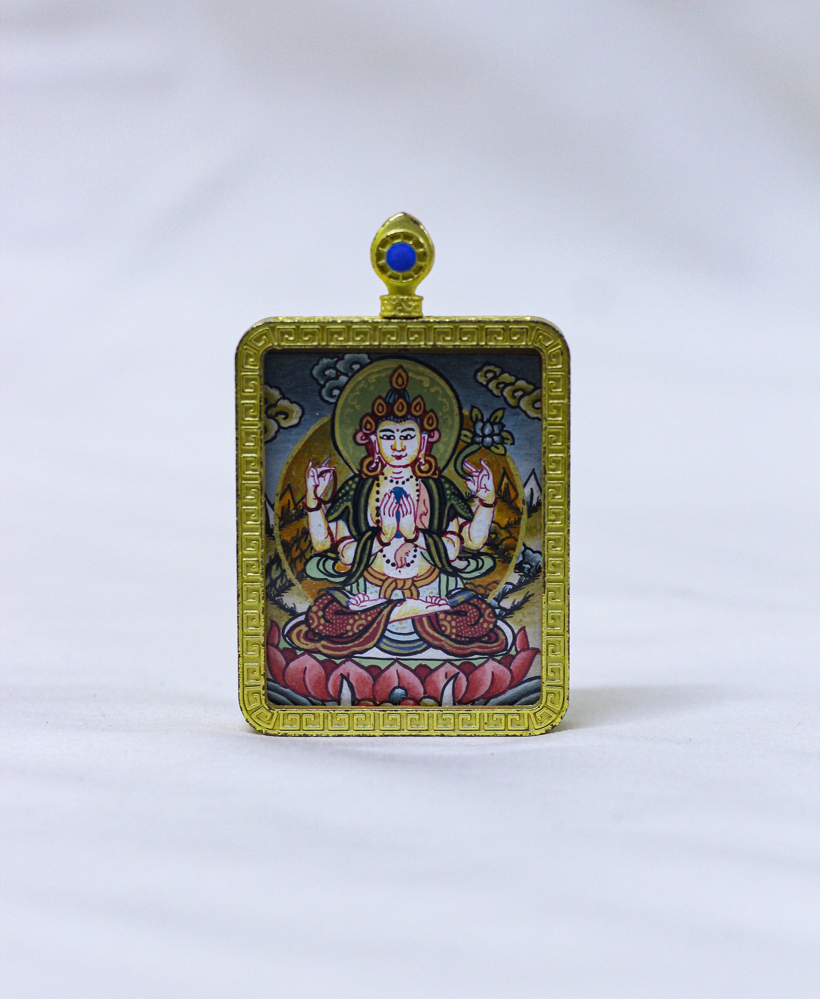 Square hand-painted Chenrezig butti thangka pendant featuring the Bodhisattva of compassion in a gold locket frame