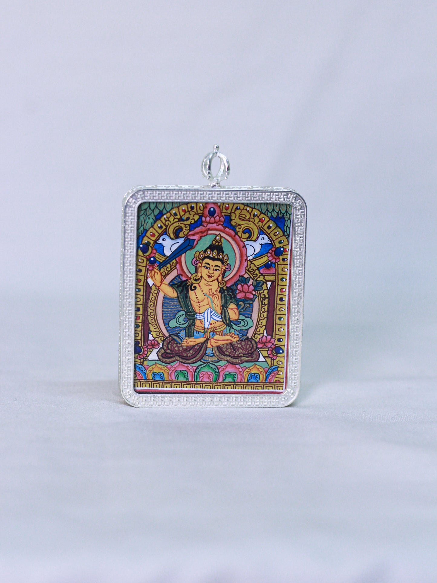 A rectangular silver-toned Manjushri thangka butti pendant. Spiritual buddhist amulet locket