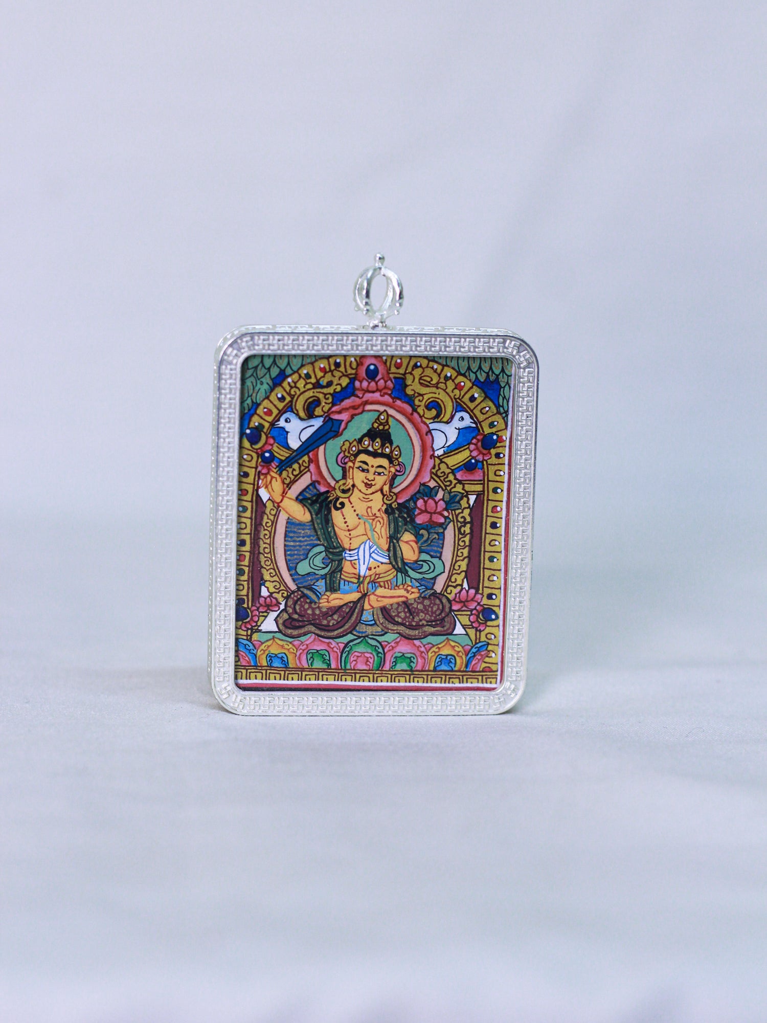 A rectangular silver-toned Manjushri thangka butti pendant. Spiritual buddhist amulet locket