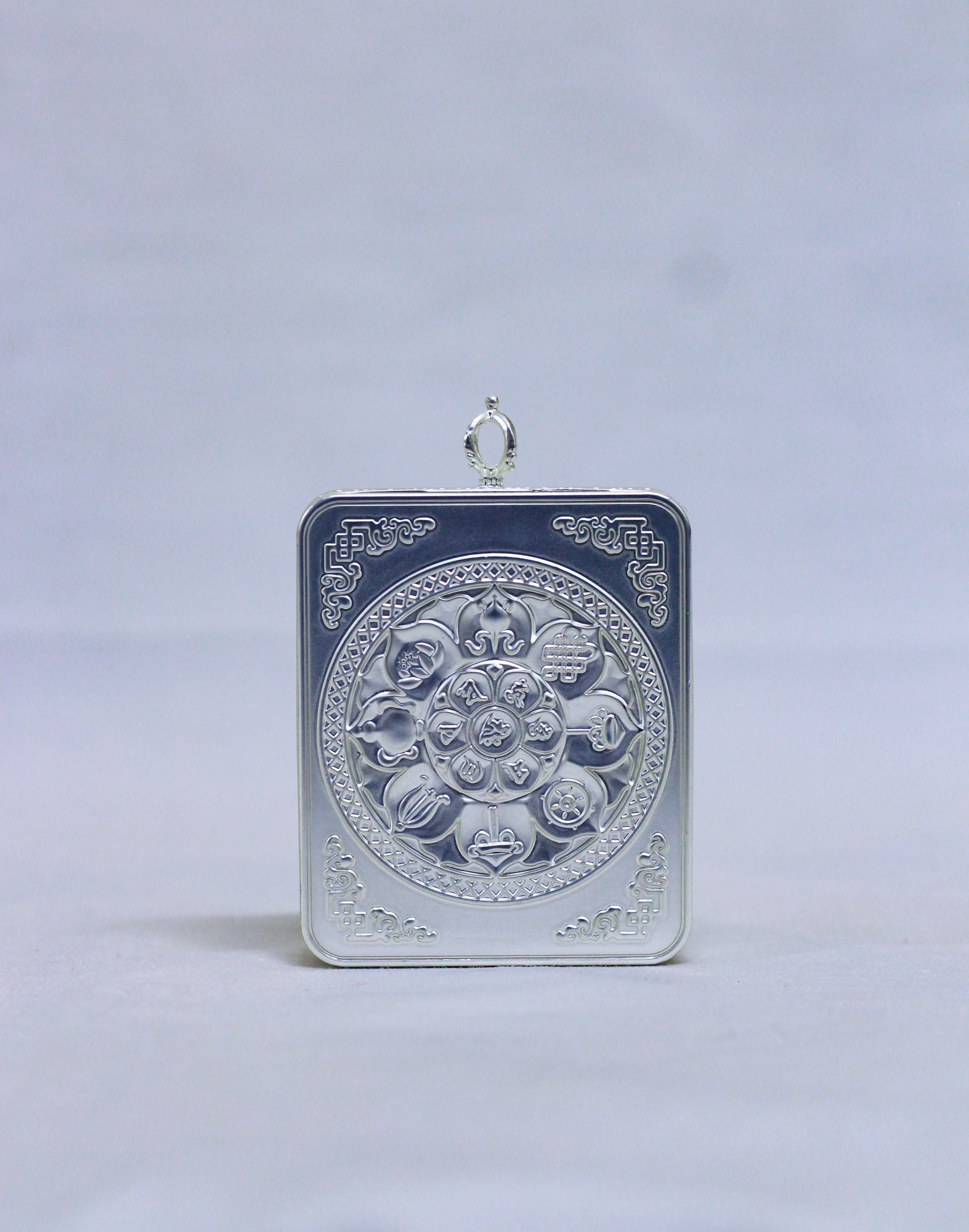 Back view of Amitabha Buddha butti thangka pendant showing silver-toned handcrafted metal finish and pendant structure