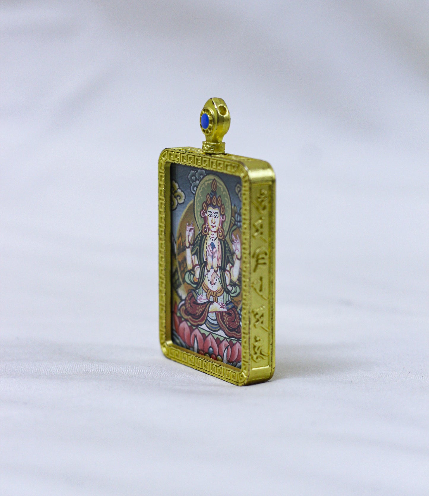 Side profile of the square Chenrezig butti thangka pendant showcasing its handcrafted locket depth and elegant construction