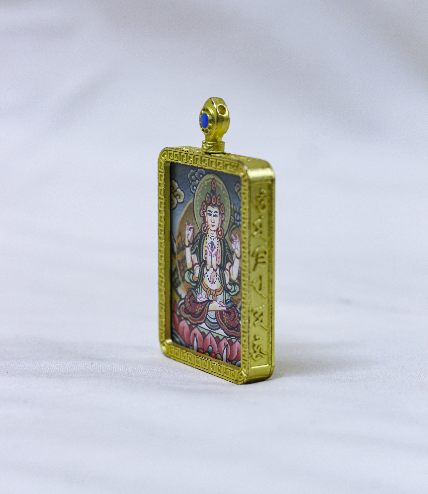Side profile of the square Chenrezig butti thangka pendant showcasing its handcrafted locket depth and elegant construction